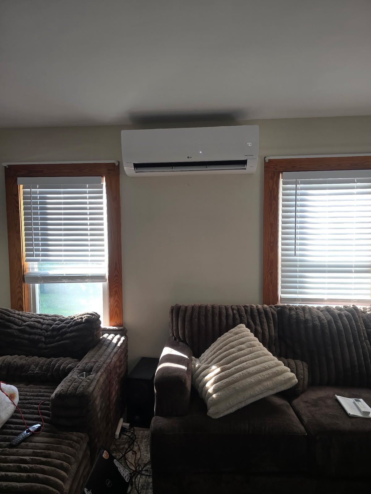 Indoor wall-mounted ductless unit between two windows